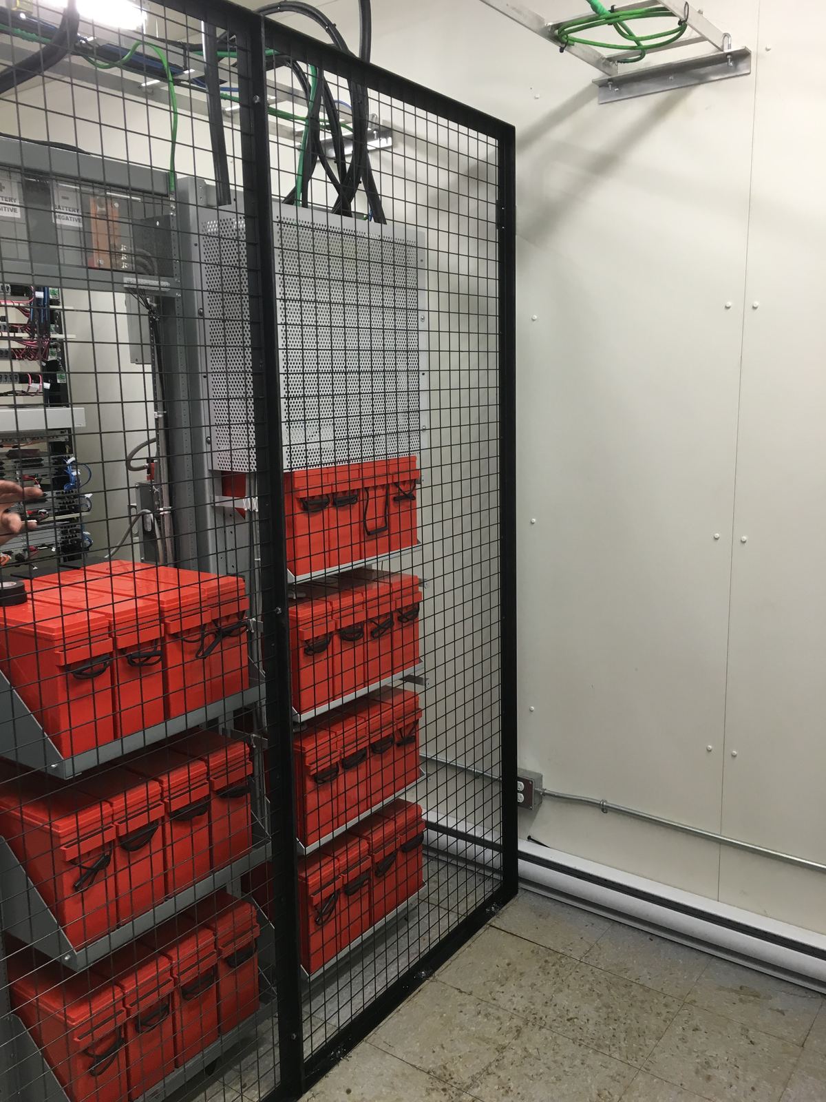 Equipment shelter interior with battery banks and power systems